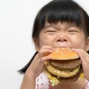 Little Girl Eating a Burger
